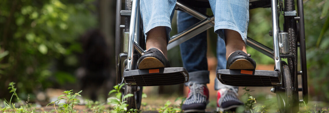 A woman being pushed in a wheelchair