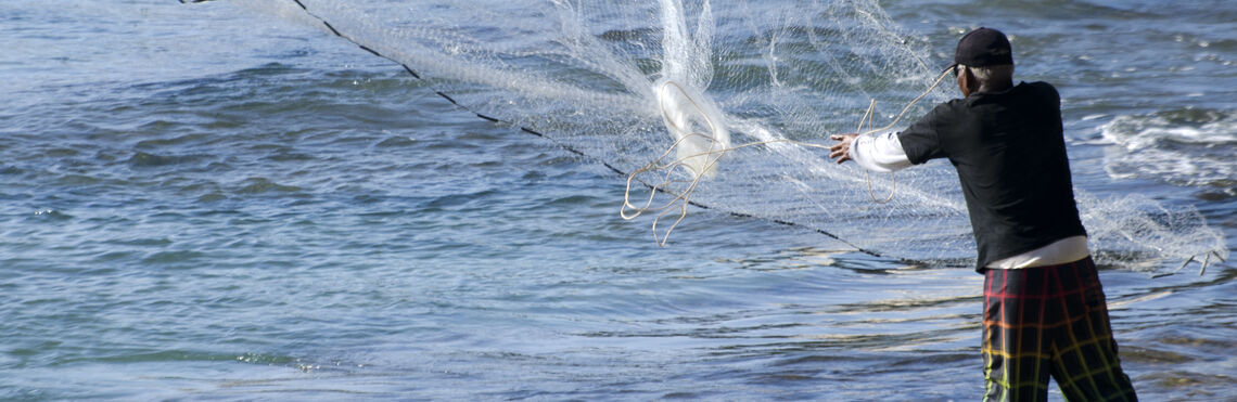 Fisherman casting a large net